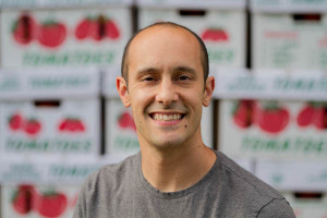 Mikey Azzara  in front of a load of ripe Jersey tomatoes. Photo: courtesy Zone 7.
