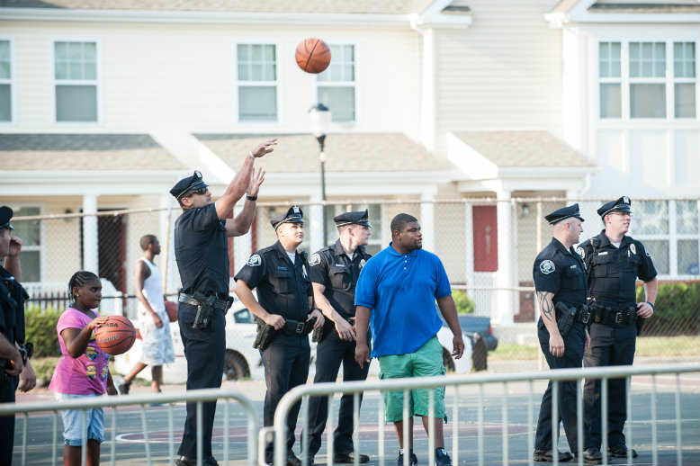County police officers shoot hoops with residents of Camden's Centerville section during an outdoor Meet Your Neighborhood Police Officers Festival.