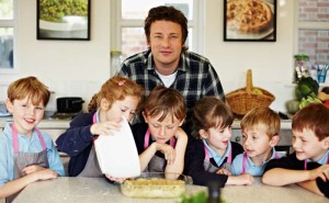 Chef Jamie Oliver with kids in his Kitchen Garden Project.