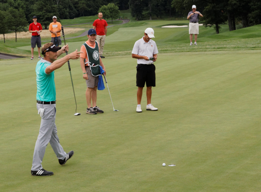 With victory assured, Hall rallies the crowd before tapping in his birdie putt on 18. Photo: Eric Levin