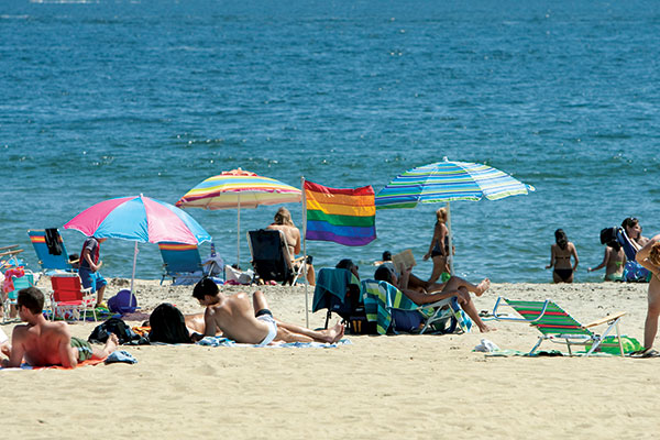 A rainbow flag sits among beachgoers in Asbury Park.