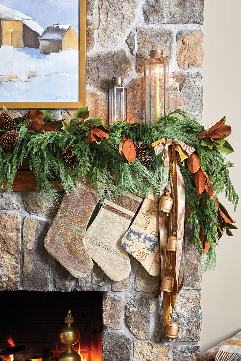 Christmas stockings and greenery on a stone fireplace in a Mendham Township home