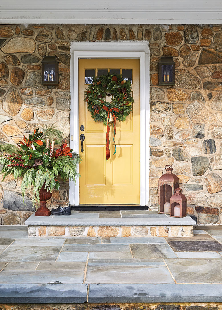 Stone exterior of Mendham Township home, with a Christmas wreath on the yellow door