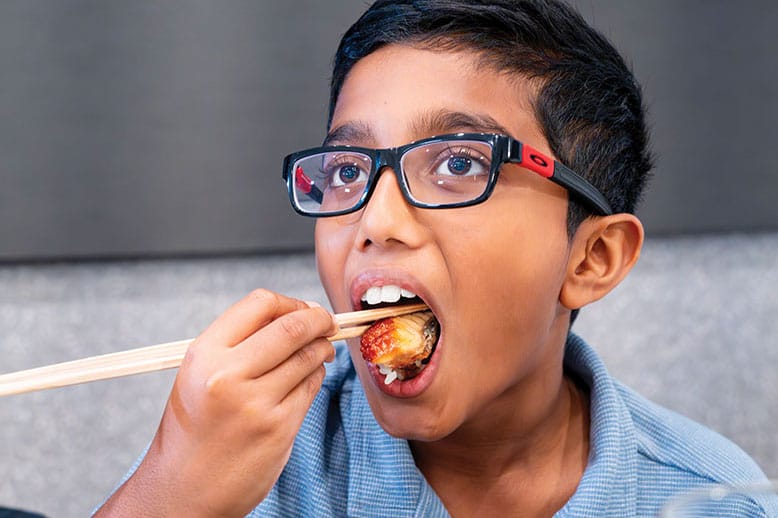 Child eating sushi