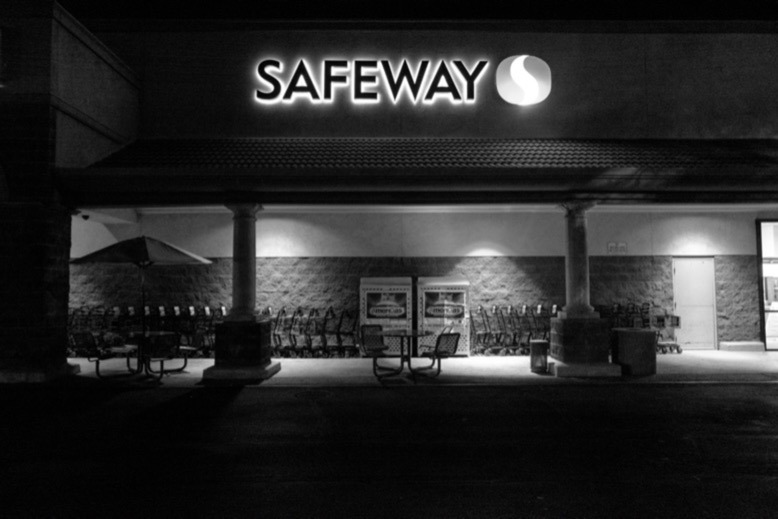 A black-and-white photograph of a Safeway store in Tucson, Arizona, the site of a 2011 mass shooting