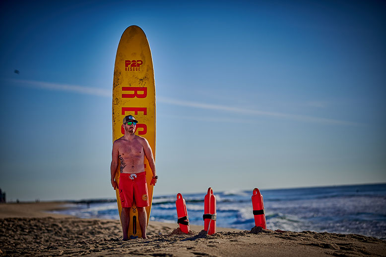 Pat Hunt holds a rescue board at Ocean Grove