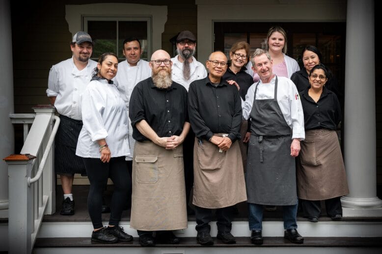 Chef Tom Carlin and staffers who have 10+ years of service to Gladstone Tavern on the front steps of the Gladstone restaurant