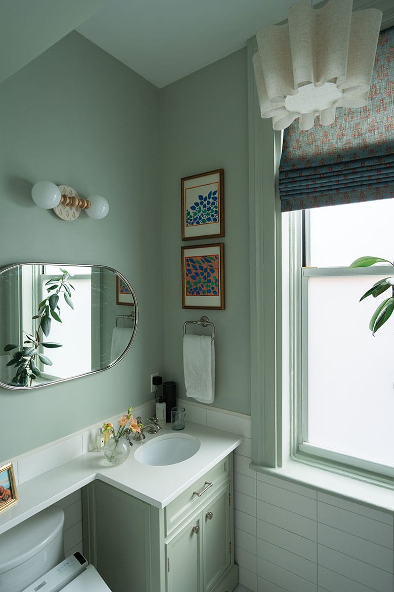 A bathroom in a Hoboken brownstone is awash in minty green hue