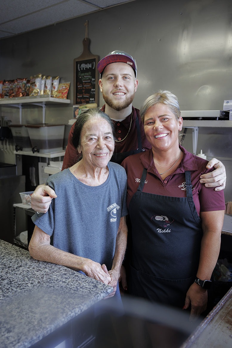 Phillip Catlett embraces his mom, Nichole Maul, right, and grandmother Rochelle Maul, who is the great-granddaughter of Jim's Lunch founder, Jim Arnes