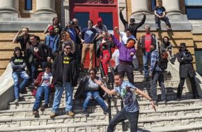 Students on the steps of the Kubert School in Dover, celebrating National Superhero Day