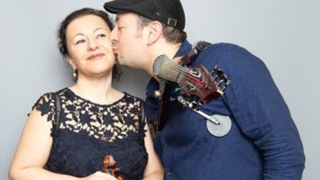 Violinist Joe Deninzon kisses his wife, violinist Yulia Ziskel