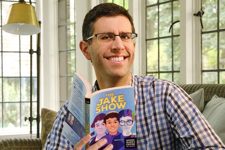 Joshua S. Levy holds a copy of his latest book, "The Jake Show"