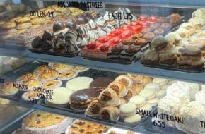 An assortment of sweet treats behind glass at Artazu Bakery Cafe in Montclair