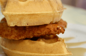 Chicken and waffles topped with warm syrup at Grits & Grace in Bayville