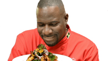 Chef Wenford Patrick Simpson admires a platter of food