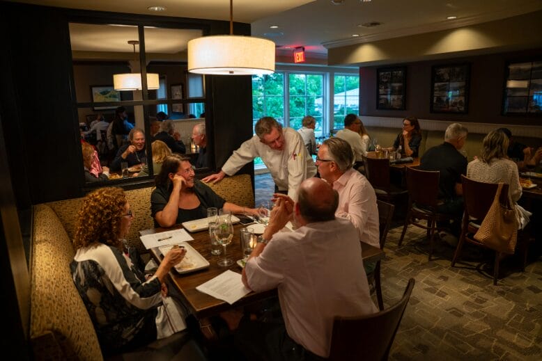 Chef Tom Carlin visits with diners in Gladstone Tavern’s main dining room