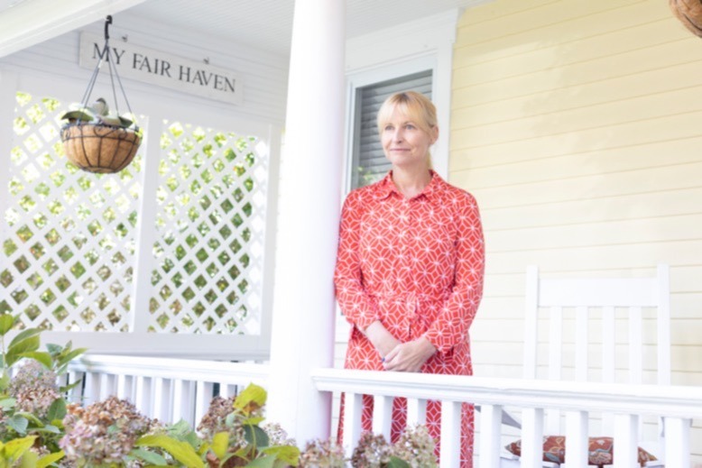 Meredith O’Brien on the porch of her Fair Haven home