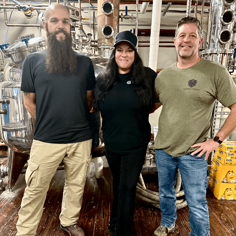 Brothers Gordon and Mike Geerhart with bartender Rayna Funari at Milk Street Distillery in Branchville