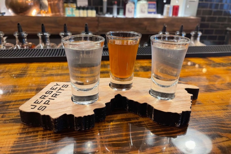 A flight of liquors at the Jersey Spirits tasting room on a Jersey-shaped board