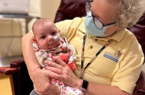 A volunteer cuddles a baby at in the NICU at Children’s Specialized Hospital in New Brunswick