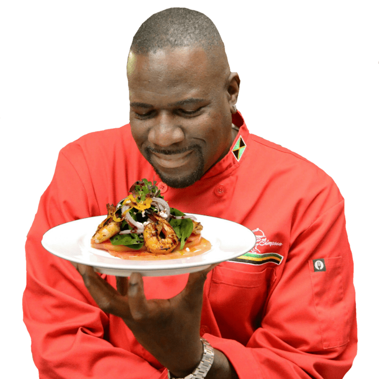 Chef Wenford Patrick Simpson admires a platter of food