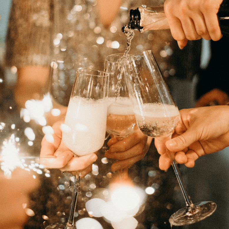 People pouring and toasting Champagne at New Year's Eve party