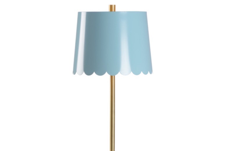 Meg Braff’s brass table lamp with a blue scalloped shade