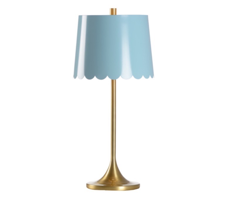 Meg Braff’s brass table lamp with a blue scalloped shade