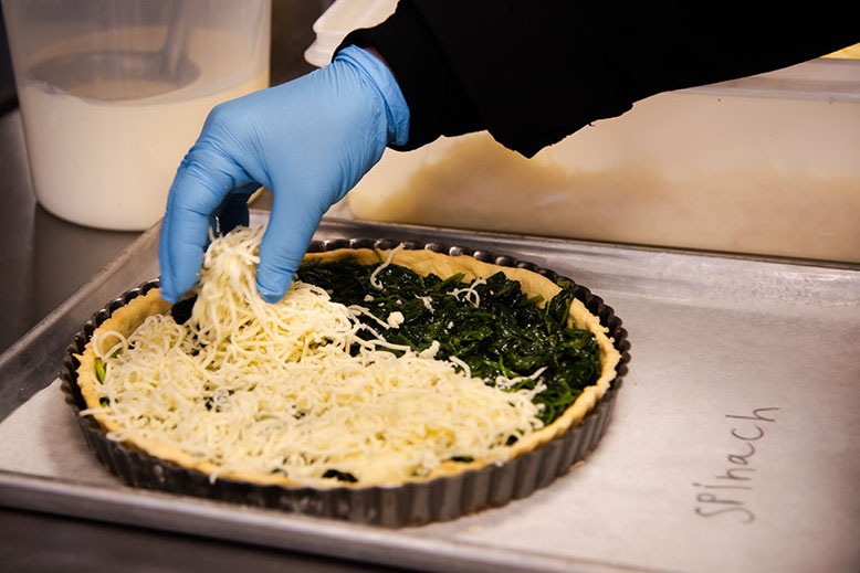 An employee preps a spinach quiche at Blue Bears Special Meals in Princeton