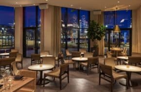 Dining room tables and chairs with a view of New York City