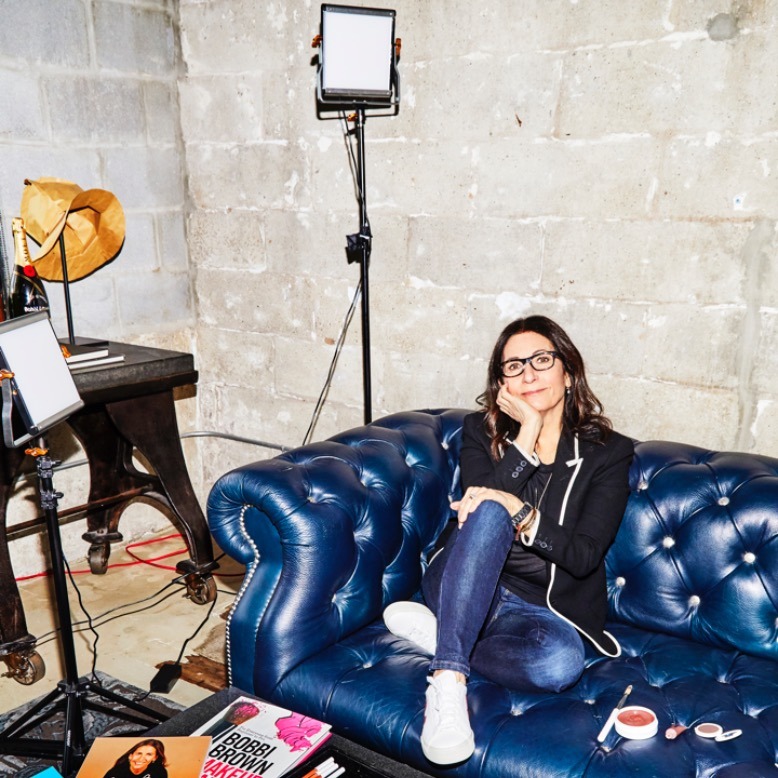 Bobbi Brown lounges on a blue couch in her Montclair office.