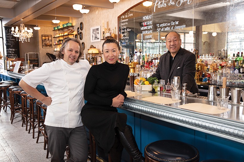 Chef Thomas Ciszak with his wife, Evelyn, the restaurant’s manager, and co-owner Michael Chin, pose at the bar.