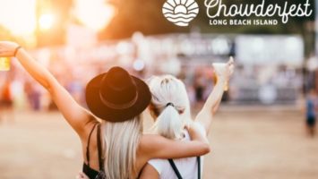 Two women holding beer and embracing each other at an outdoor festival