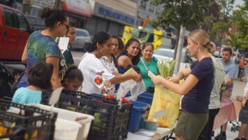 People shopping for produce at an outdoor market