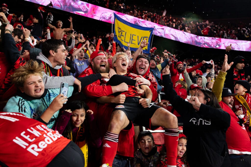 Enthusiastic fans embrace John "JMi" Tolkin of the Red Bulls