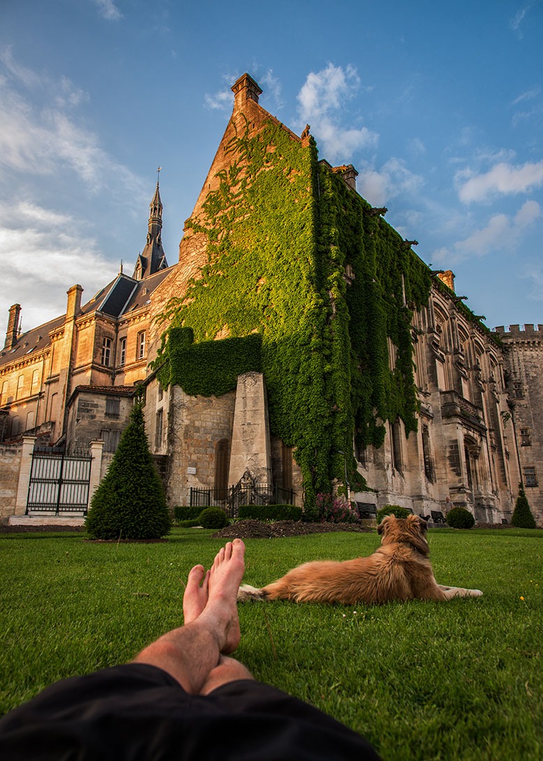 Photograph of Tom Turcich's dog, Savannah, at his feet as they relax in Angoulême, France