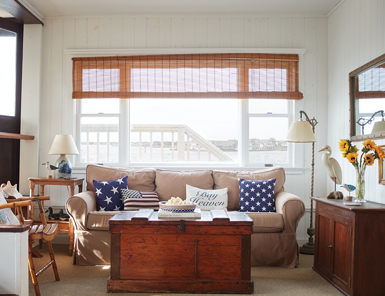 The 100-year-old houseboat's living room, filled with natural light and nautical décor.