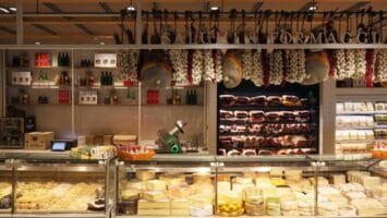 A counter at Eataly Short Hills featuring cheeses and meats