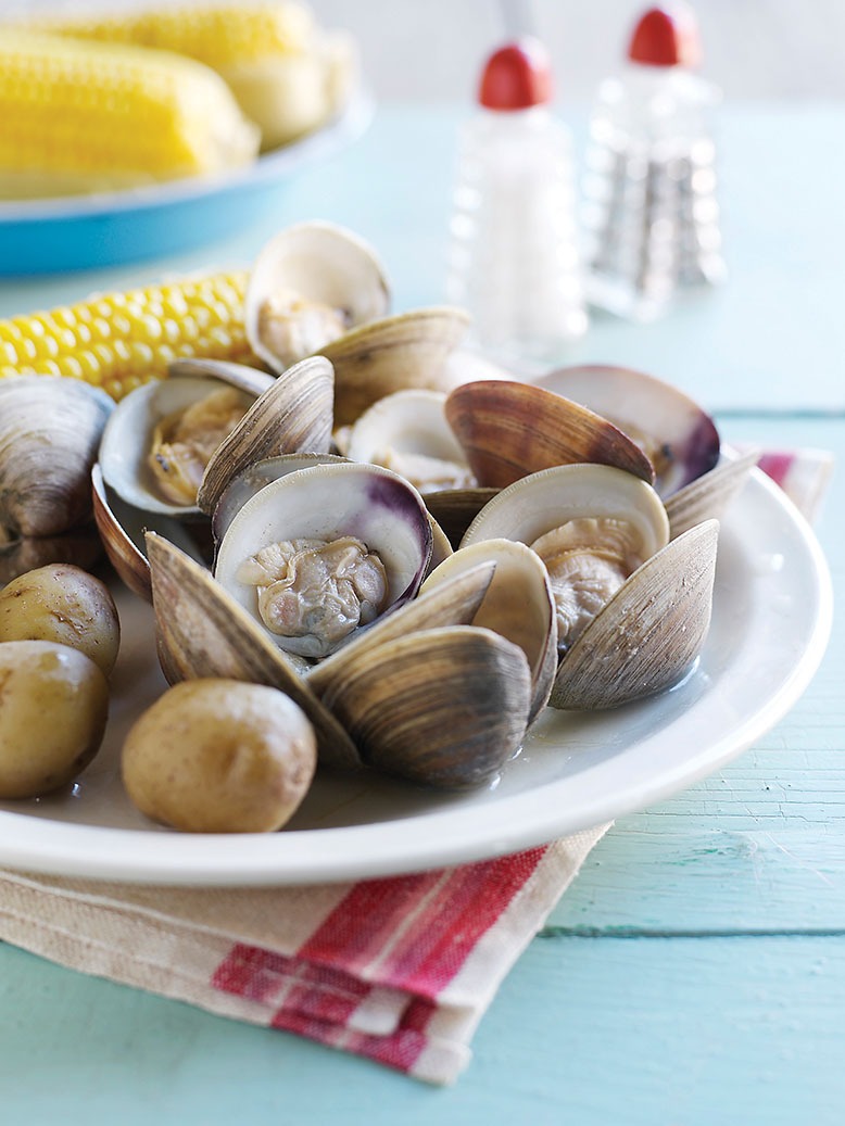 Clams on table with corn and salt and pepper shakers