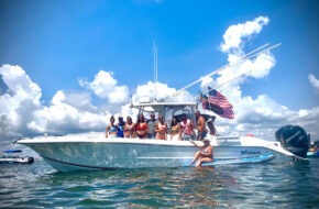 A boat of people on the water in Forked River