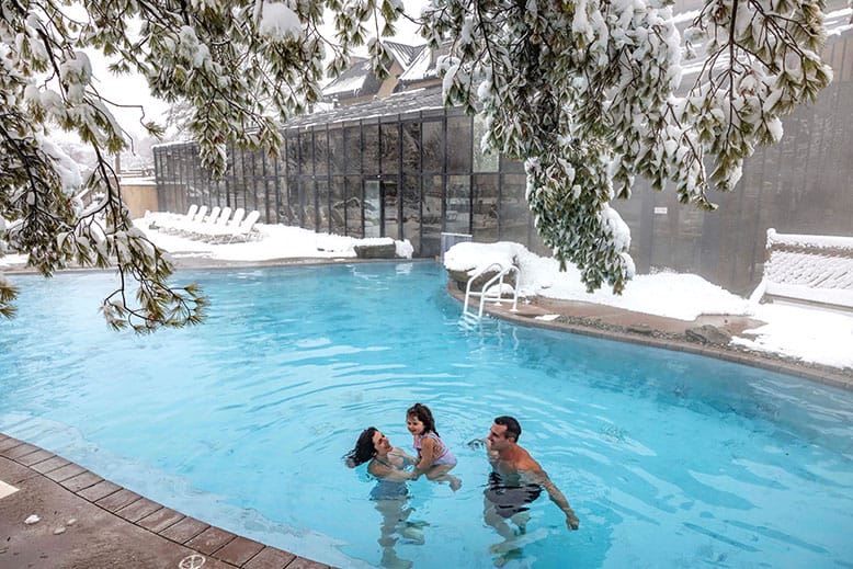 A family in the winter in the indoor/outdoor pool at Mineral Springs Hotel, part of Crystal Springs Resort in Sussex County