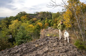 A man and his dog hike at the Quarry Point lookout