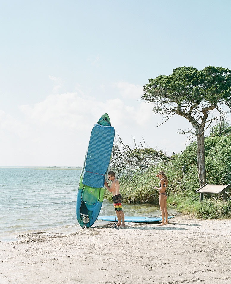 Man and woman at Island Beach State Park with kayak and surfing board