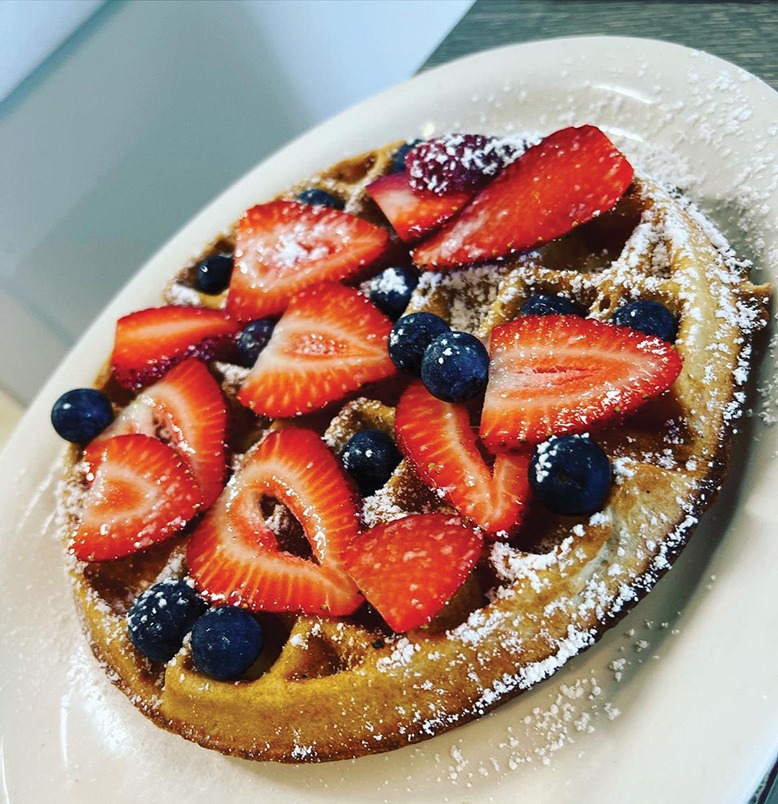 A Belgian waffle topped with fruit and powdered sugar at Klotz's Kitchen in Point Pleasant Beach.