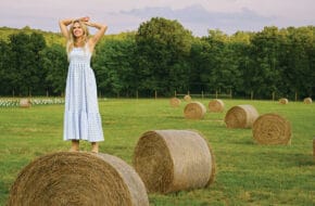 Laura Bell Bundy stands on a hay bale on her Tewksbury farm