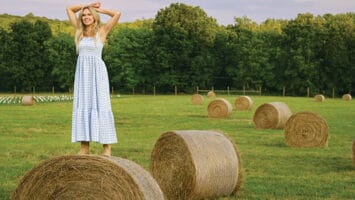 Laura Bell Bundy stands on a hay bale on her Tewksbury farm