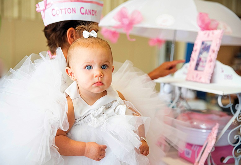 A baby dressed in all white is ready for the Ocean City Baby Parade.