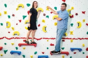 Sharon Sevrens on a climbing wall with physical therapist Scott Matthews at his West Caldwell nonprofit, Intensive Therapeutics