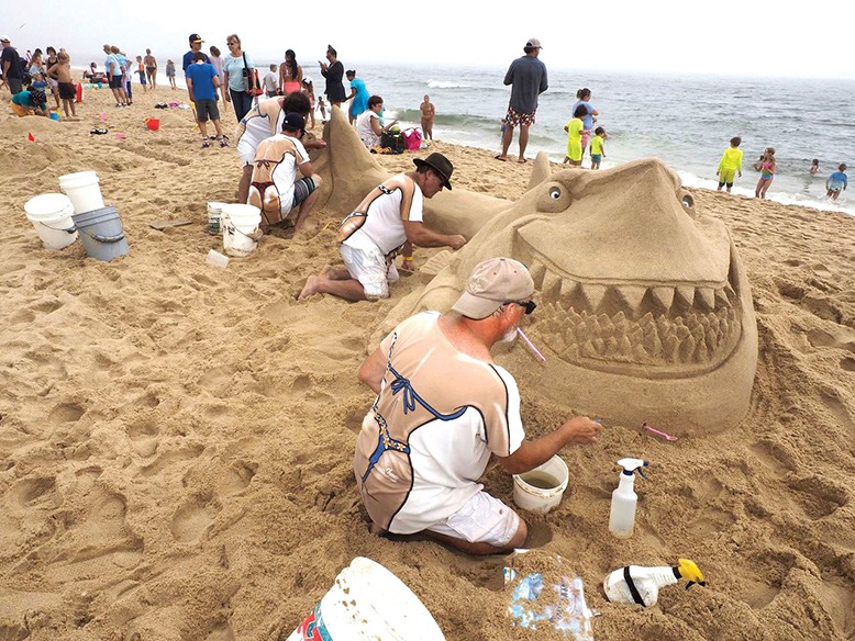 Contestants sculpt a shark out of sand on Belmar's beach.