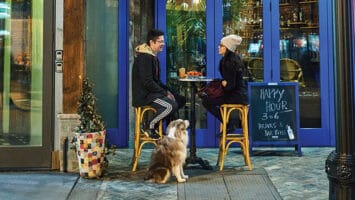 A couple and their pup sit outside a restaurant on Jersey City’s Newark Avenue